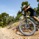 A Greyp electric mountain bike being ridden in gravel